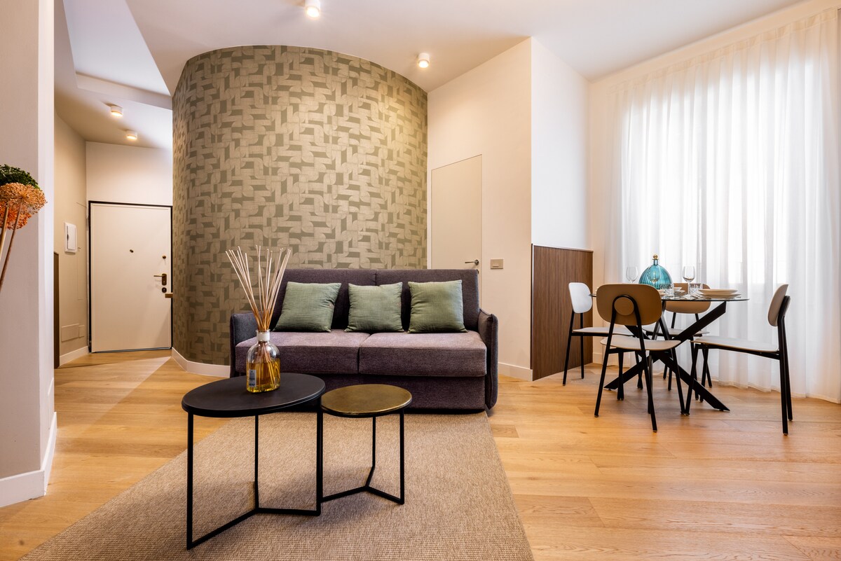 17-soggiorno-divano-zona-pranzo-dimora-montenapo-milano